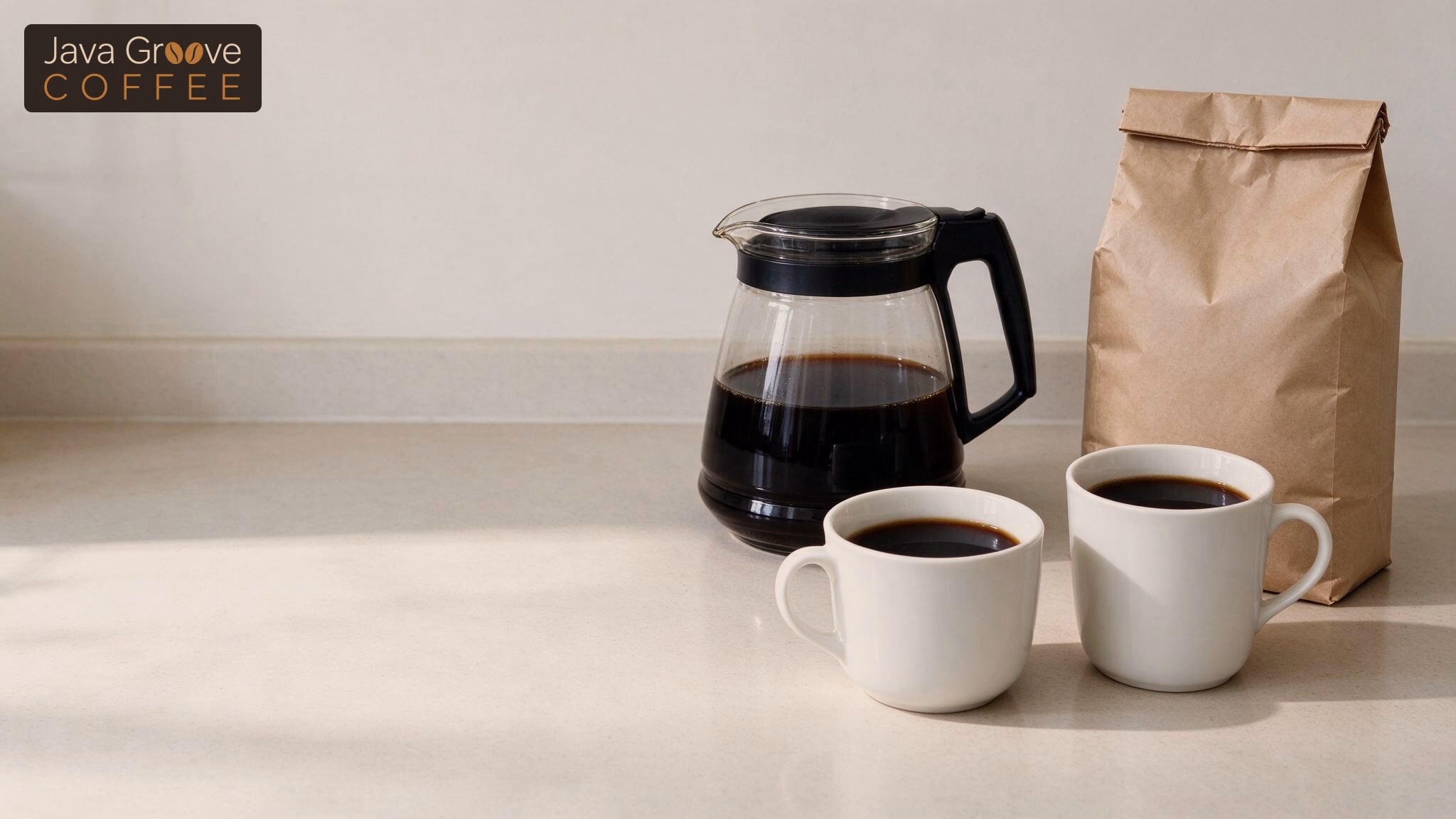 Costco Cuisinart CBC-6800PC: a glass carafe, two mugs of coffee and a bag of grounds