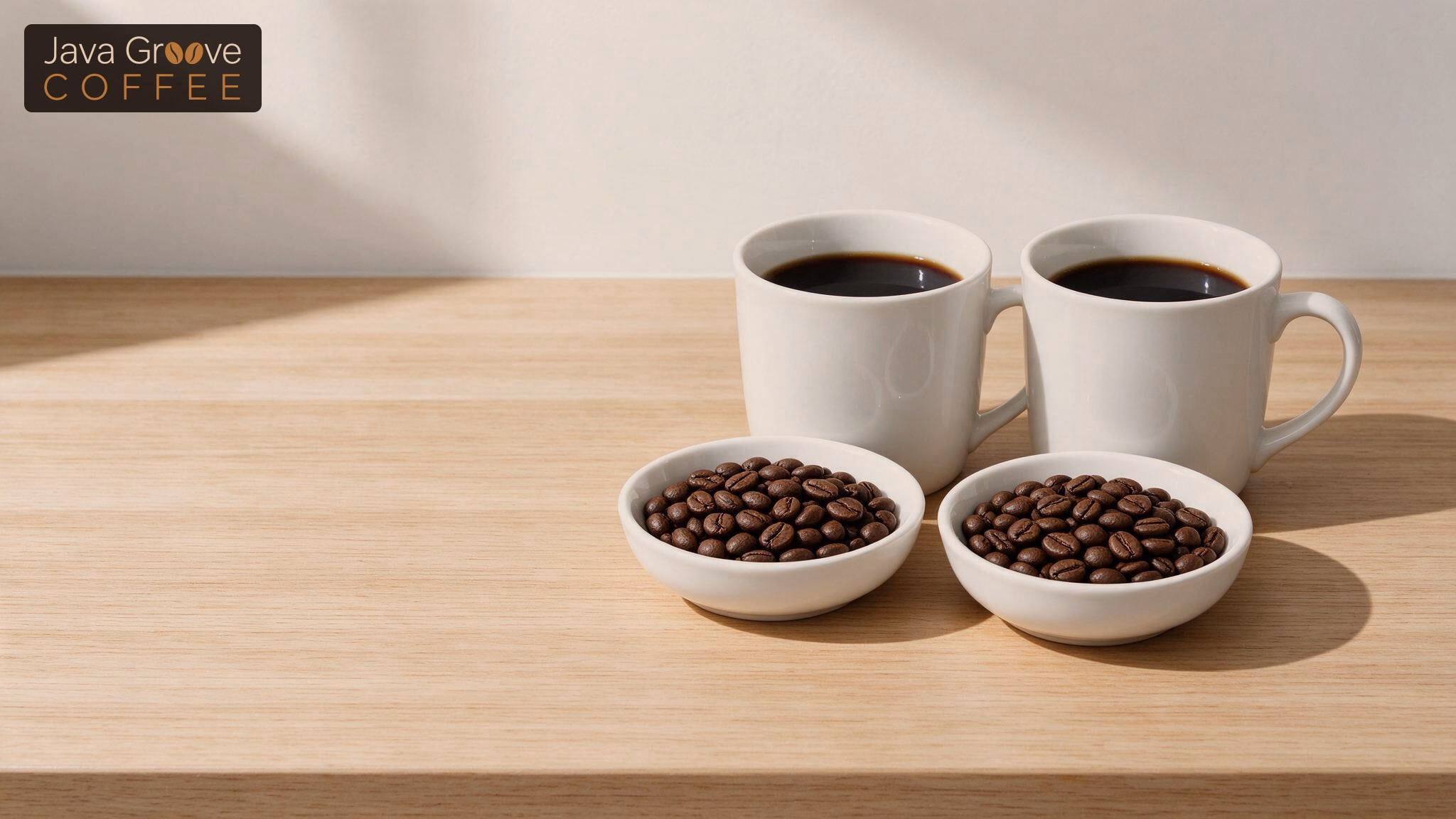 Decaf vs regular coffee: two mugs of black coffee with bowls of beans