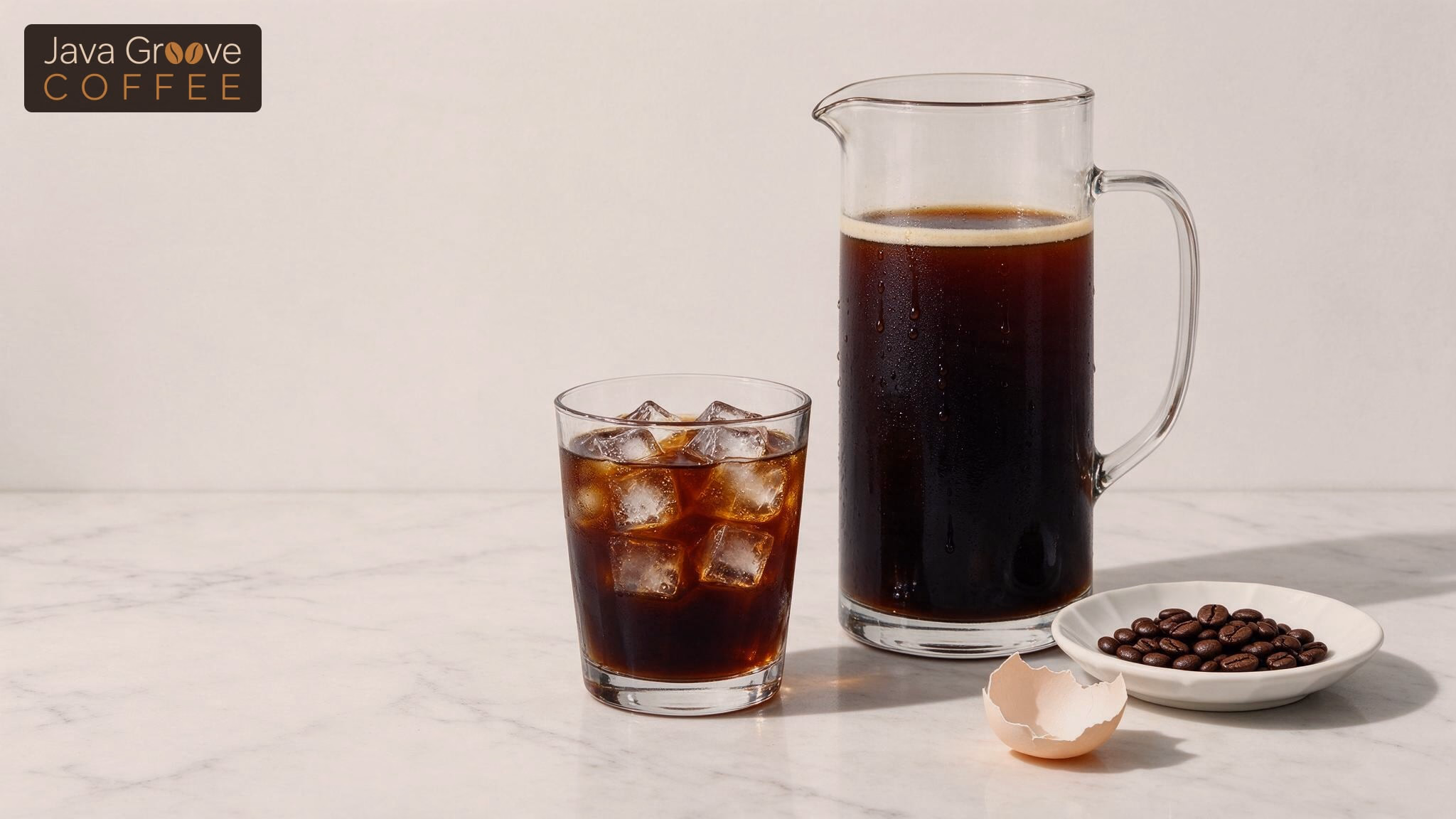 Less acidic coffee, iced cold brew and a carafe with coffee beans and an eggshell